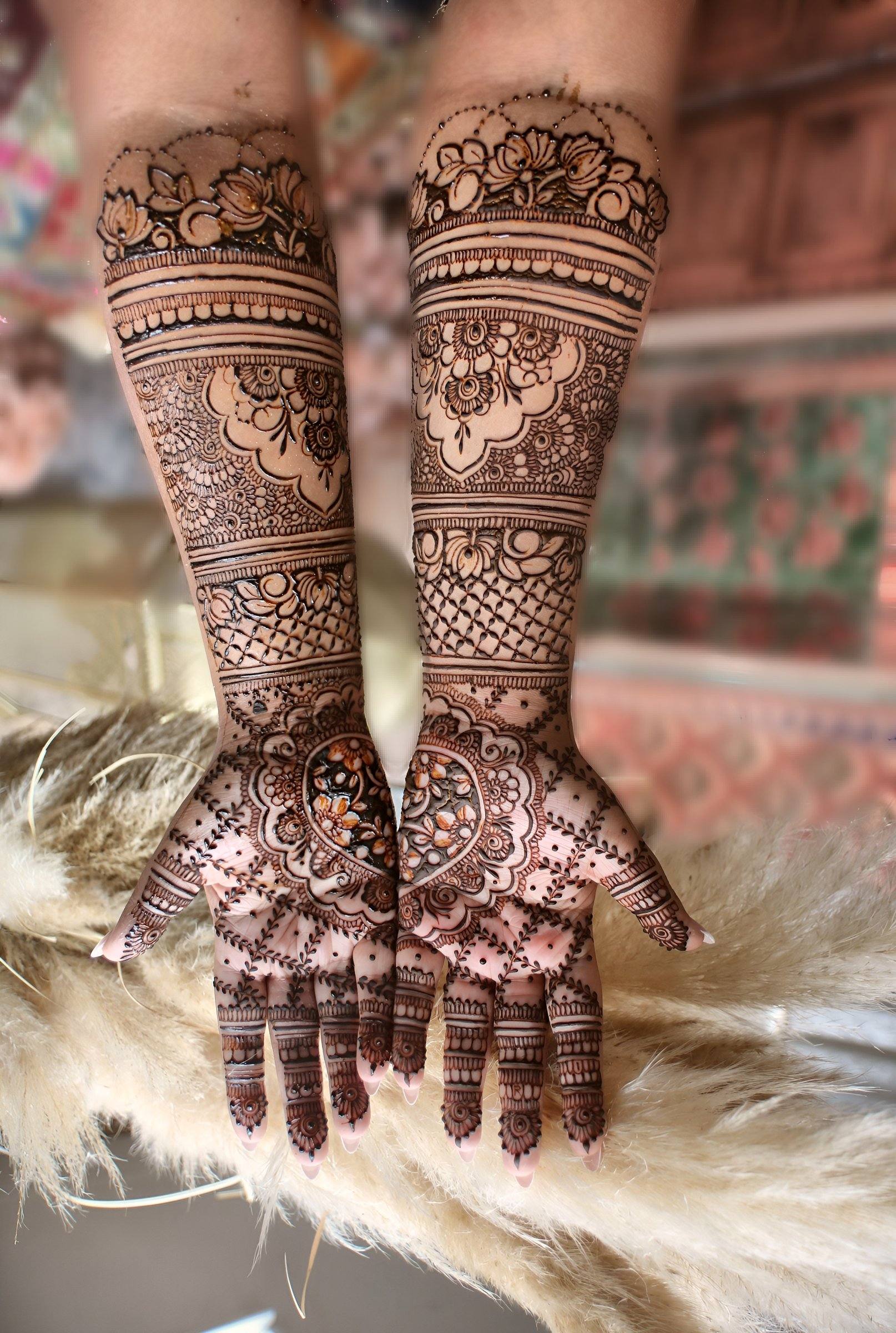 Bridal henna arms displayed over pampas grass
