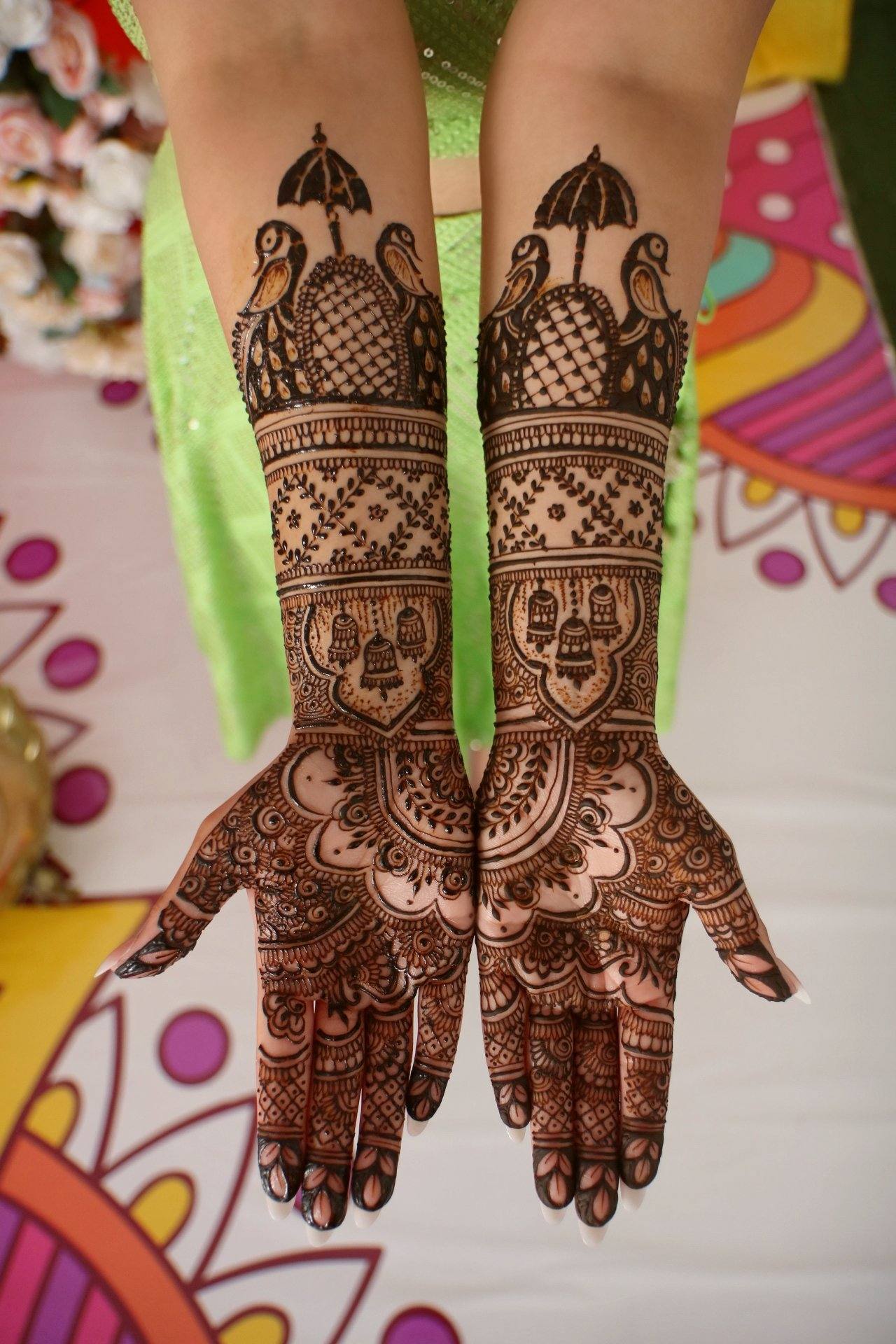 Bridal henna with palanquin and umbrella motifs on arms