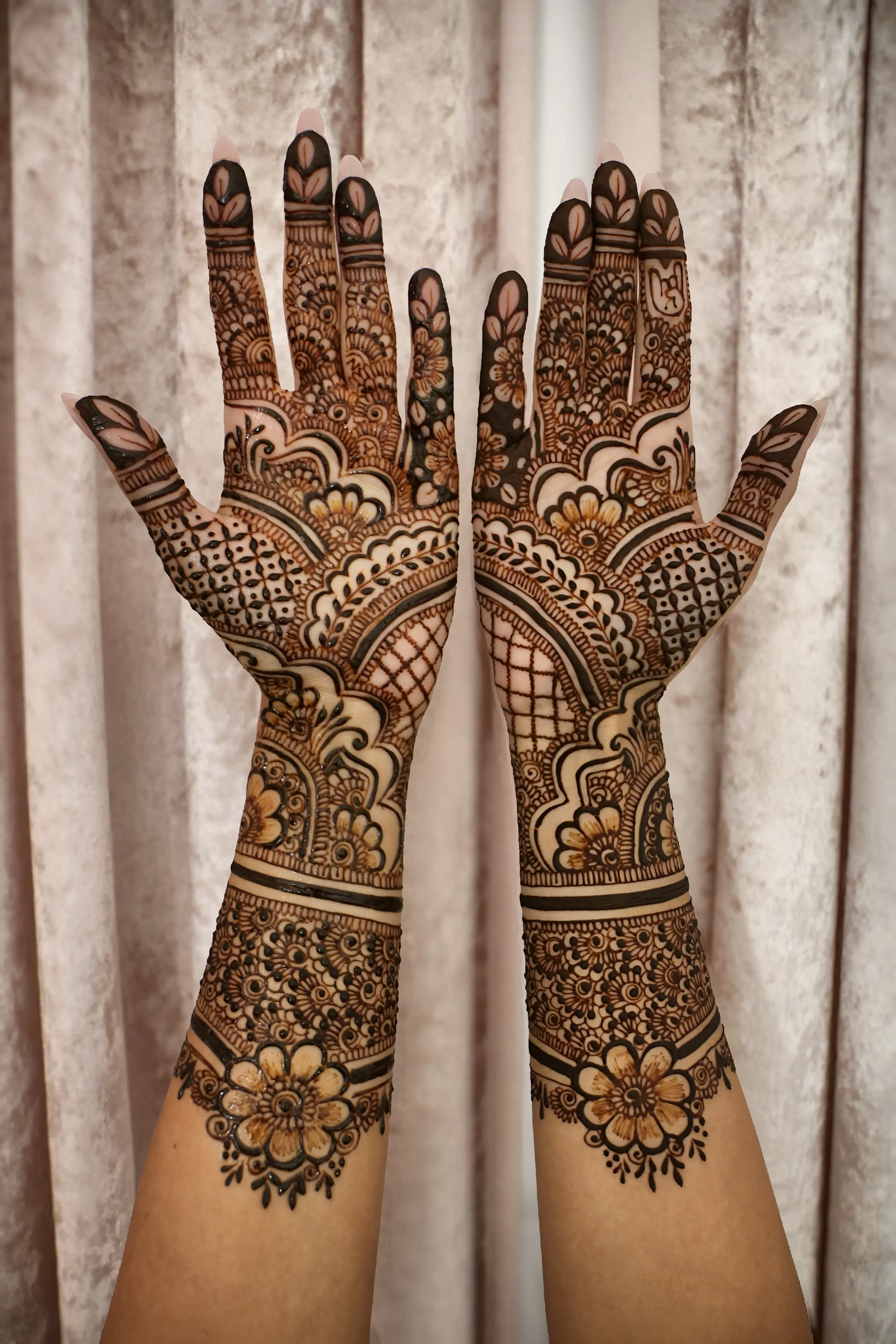 Bridal henna by Fatma Studio: intricate mehndi on both palms and forearms